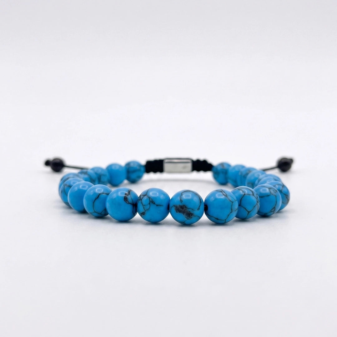 Pulsera de turquesa azul natural con nudo corredizo y espaciador metálico de la marca KRV.