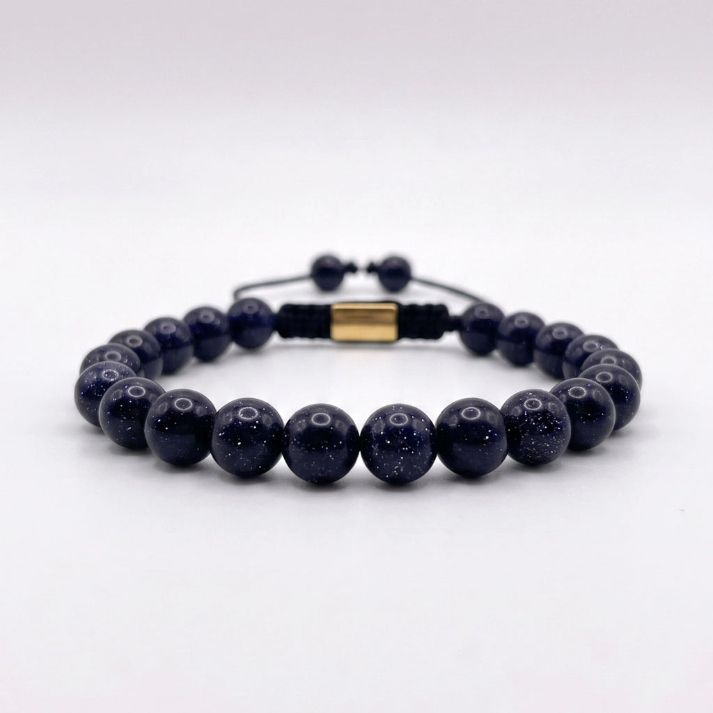 Pulsera de lluvia dorada azul con nudo corredizo y espaciador metálico de la marca KRV.