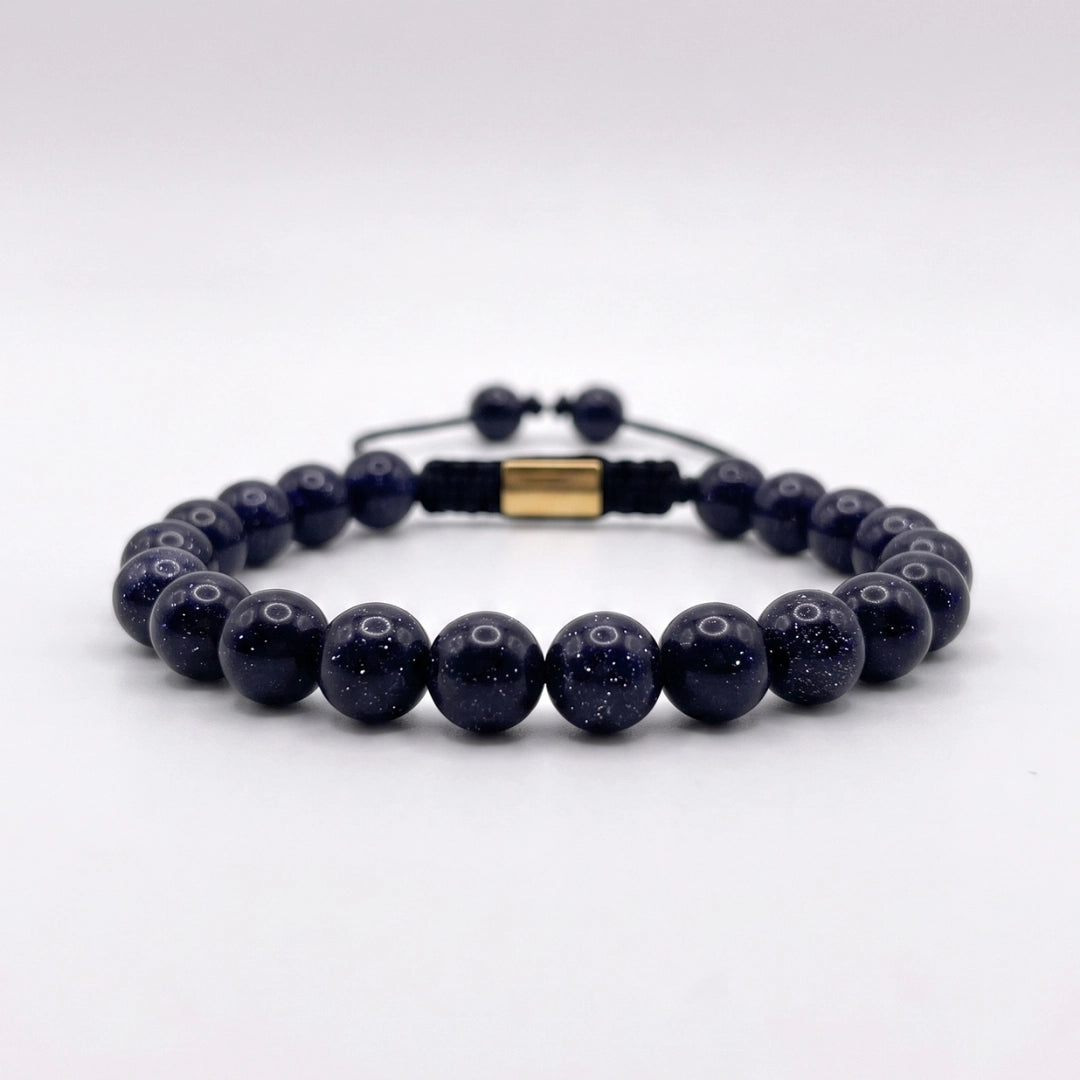 Pulsera de lluvia dorada azul con nudo corredizo y espaciador metálico de la marca KRV.