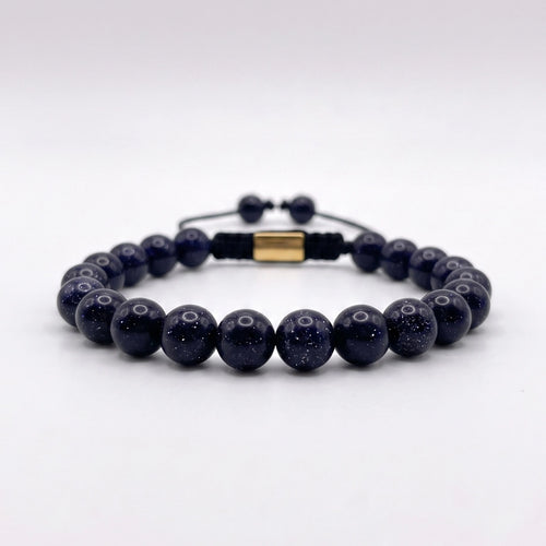 Pulsera de lluvia dorada azul con nudo corredizo y espaciador metálico de la marca KRV.