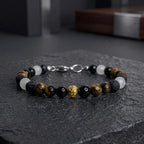 Pulsera masculina de piedras naturales ojo de tigre, turmalina negra, jade blanco y balín dorado tallado.
